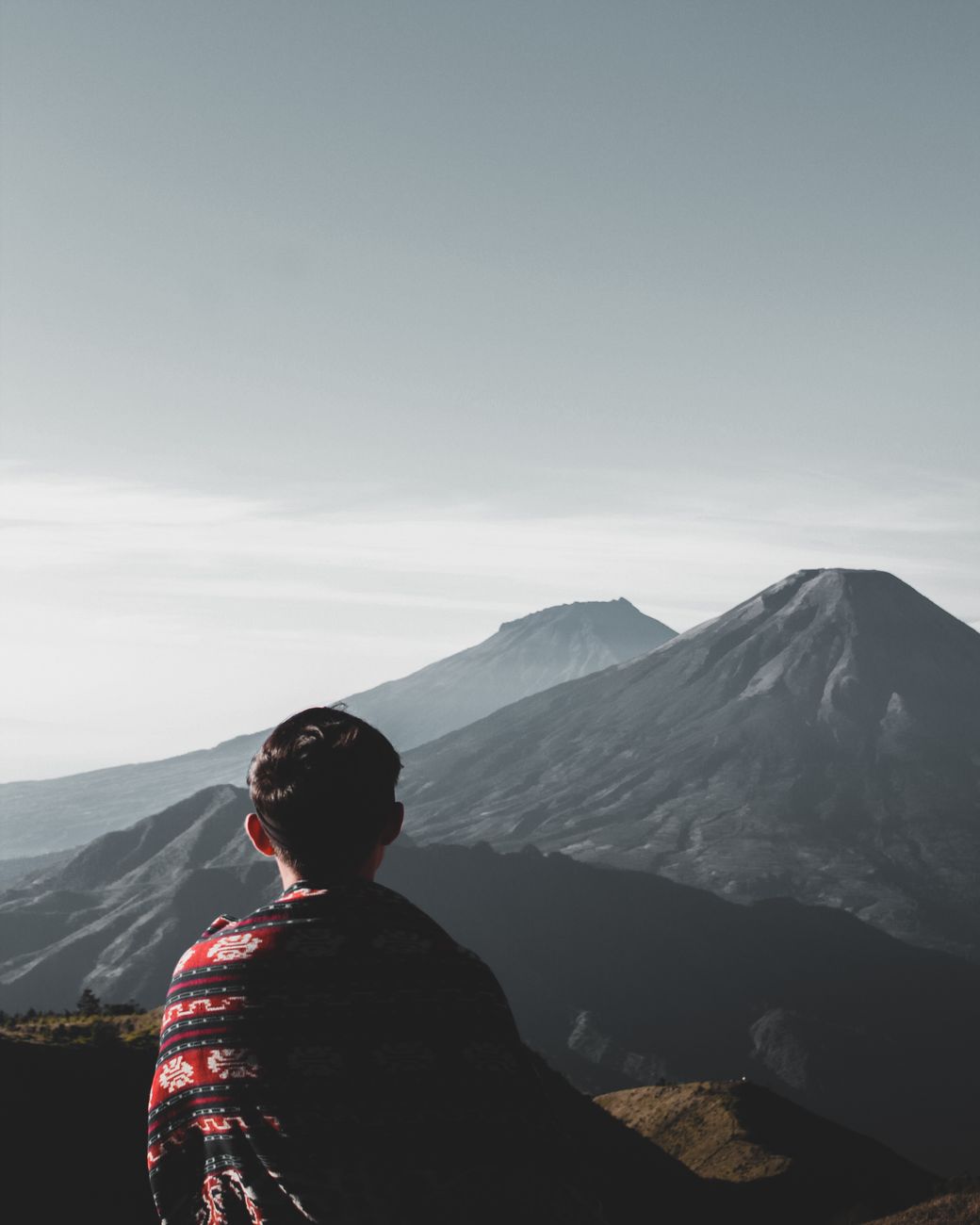 Solitary viewpoint over vast mountain horizon