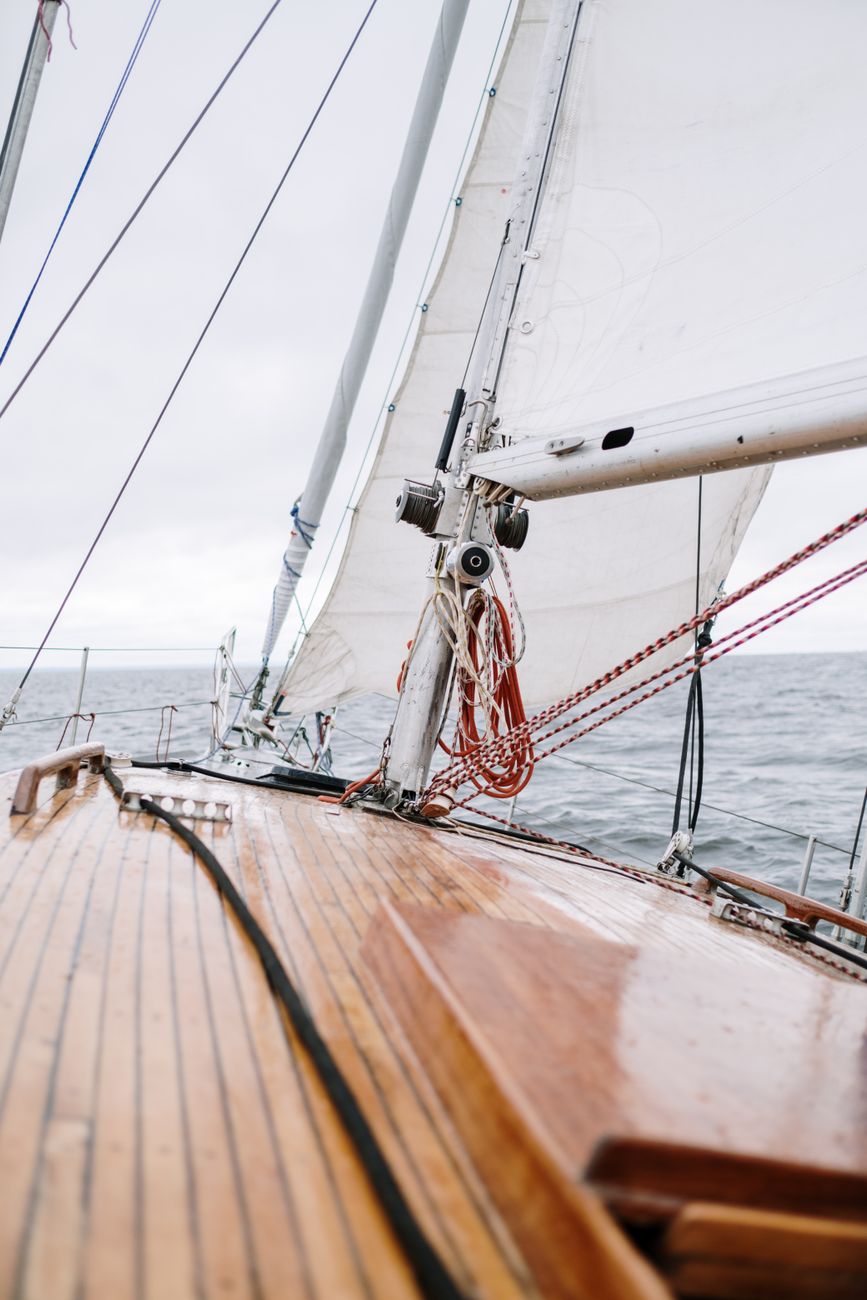 Wooden sailing boat navigating secluded crystal waters
